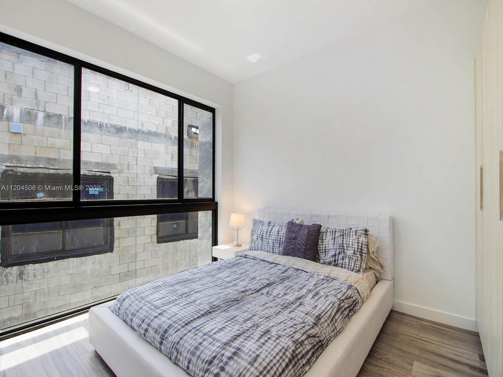 2955 Bird Avenue, Unit PHA Miami, FL 33133 - Photo 20 of 33 a bedroom with a bed and window