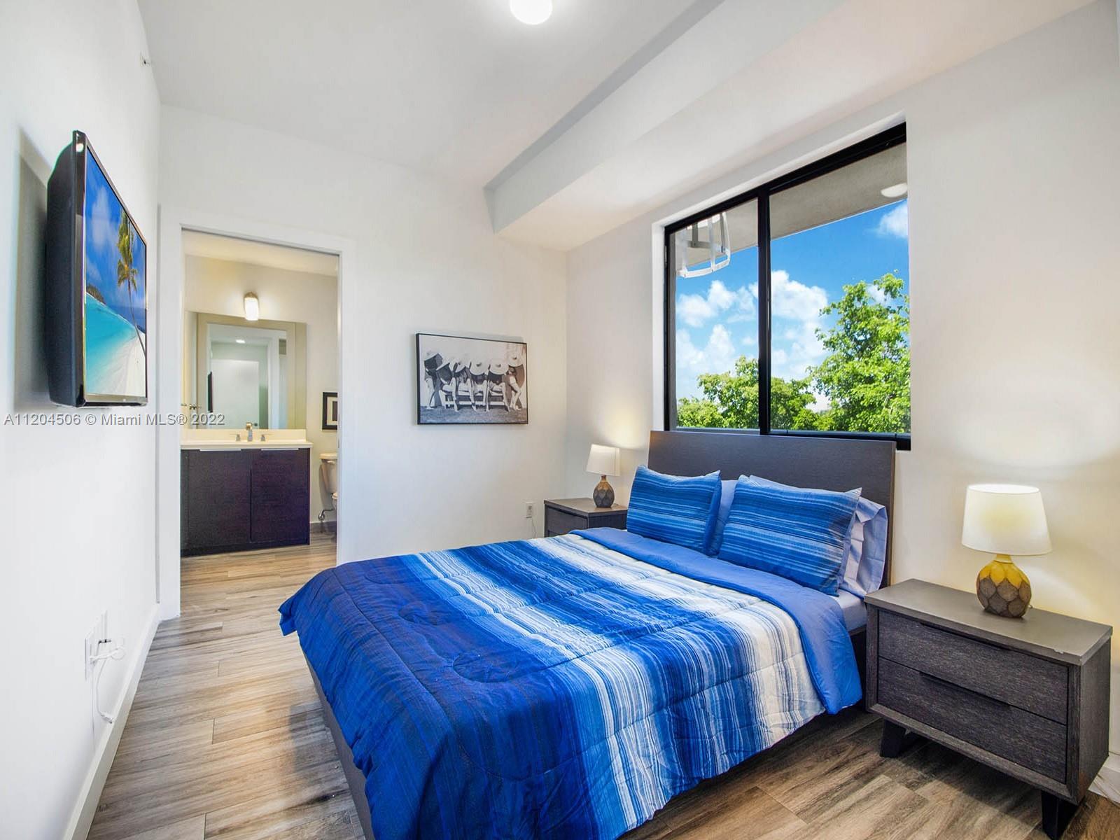 2955 Bird Avenue, Unit PHA Miami, FL 33133 - Photo 21 of 33 a bedroom with a bed and a large window