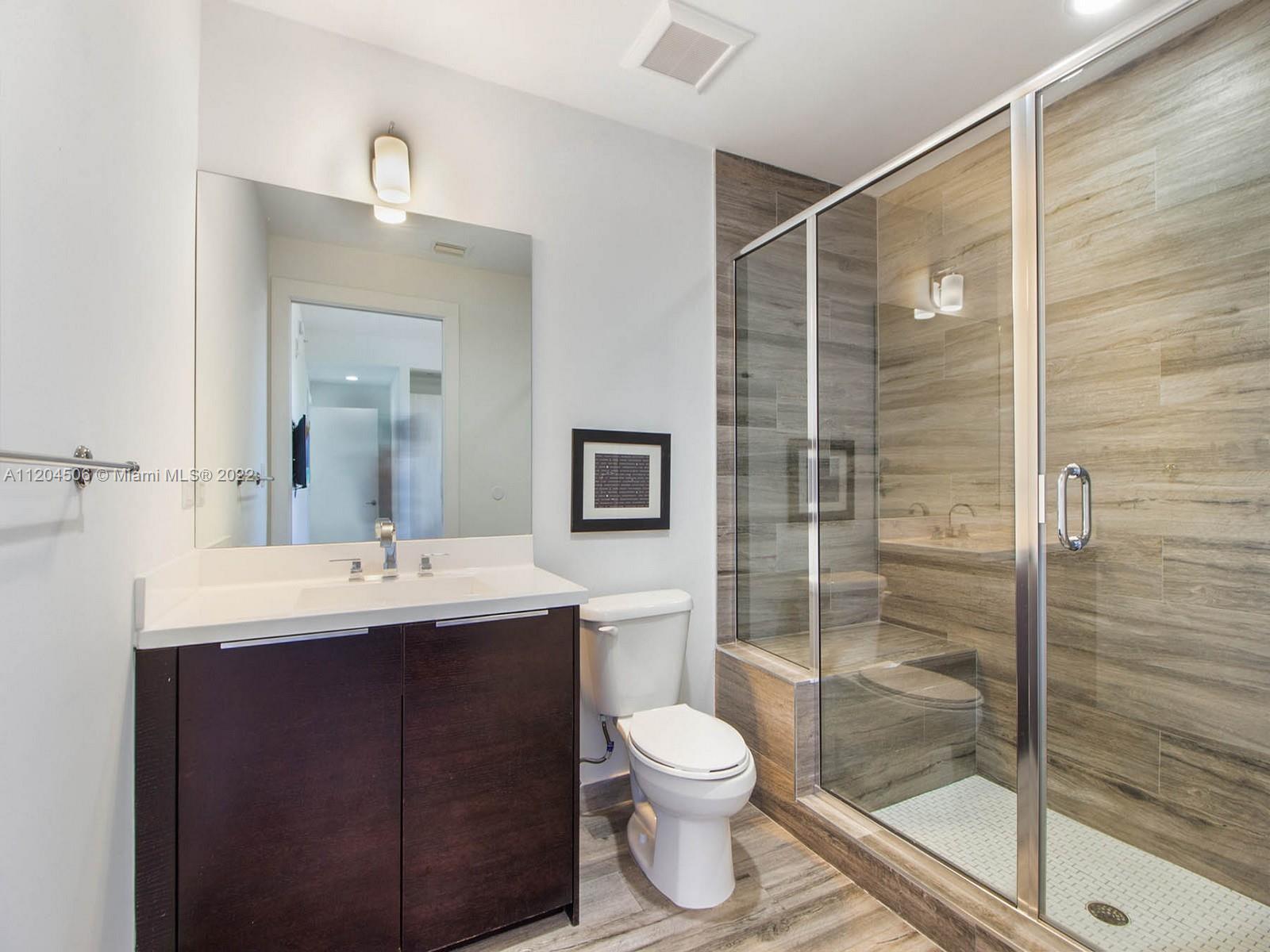 2955 Bird Avenue, Unit PHA Miami, FL 33133 - Photo 23 of 33 a bathroom with a toilet a sink and shower