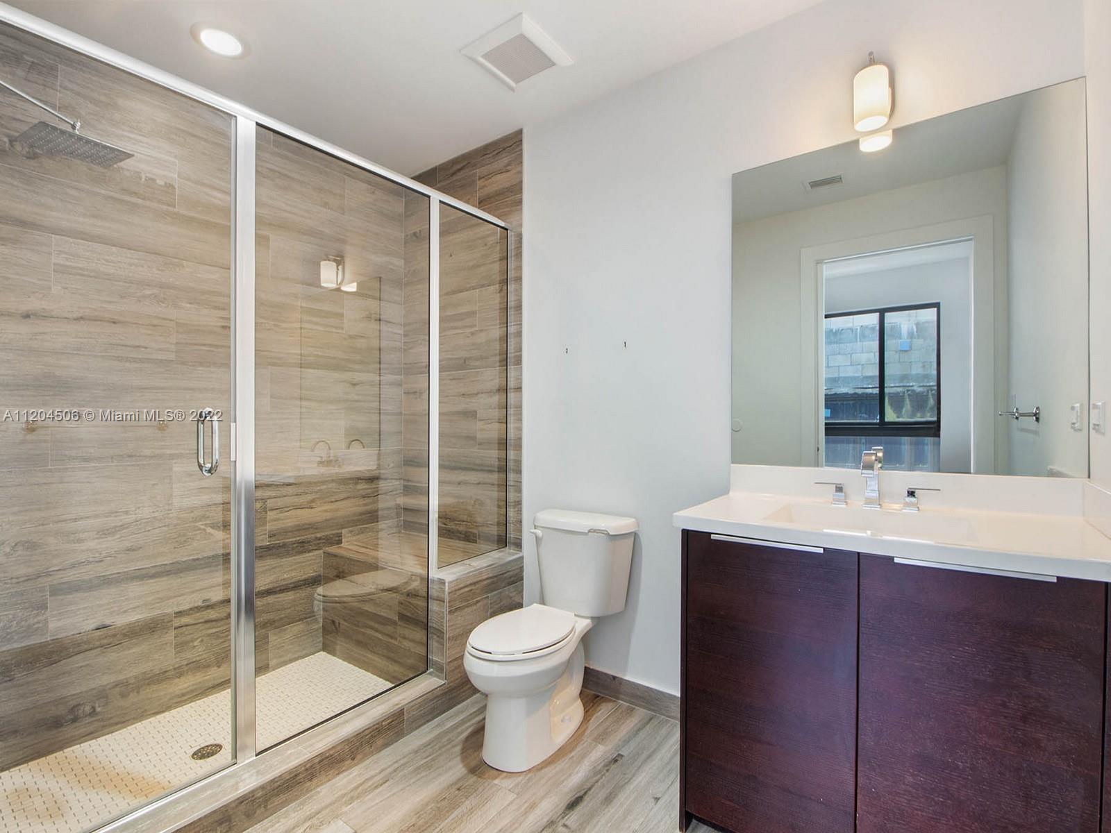 2955 Bird Avenue, Unit PHA Miami, FL 33133 - Photo 24 of 33 a bathroom with a toilet sink and a shower