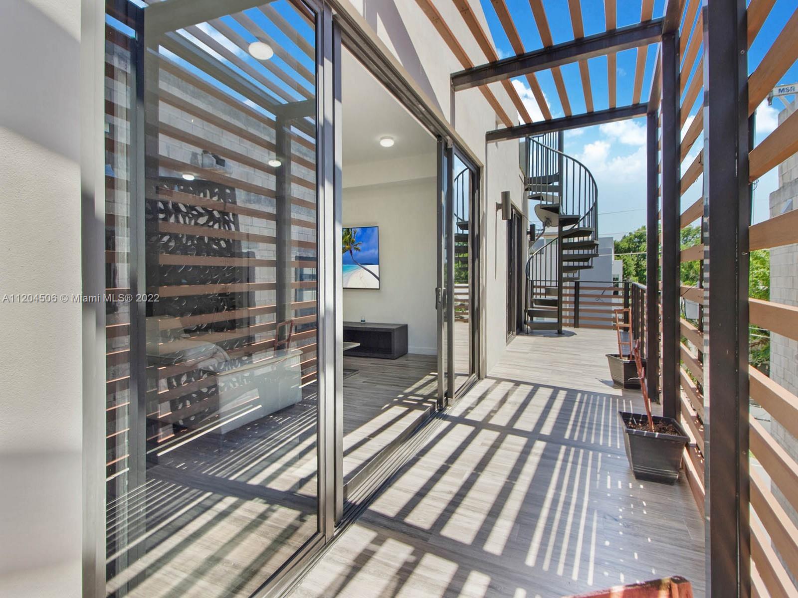2955 Bird Avenue, Unit PHA Miami, FL 33133 - Photo 25 of 33 a view of a balcony with wooden floor