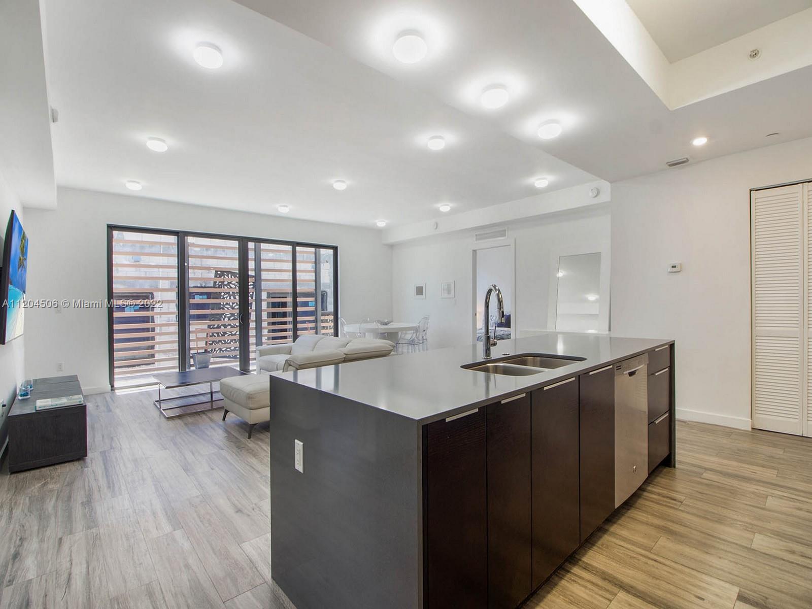 2955 Bird Avenue, Unit PHA Miami, FL 33133 - Photo 7 of 33 a kitchen with a sink and large windows