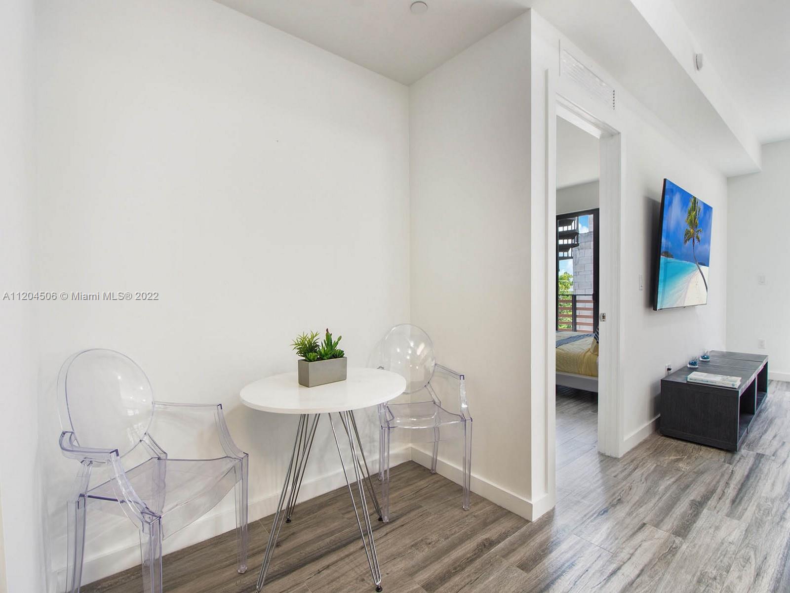 2955 Bird Avenue, Unit PHA Miami, FL 33133 - Photo 8 of 33 a living room with furniture and a wooden floor