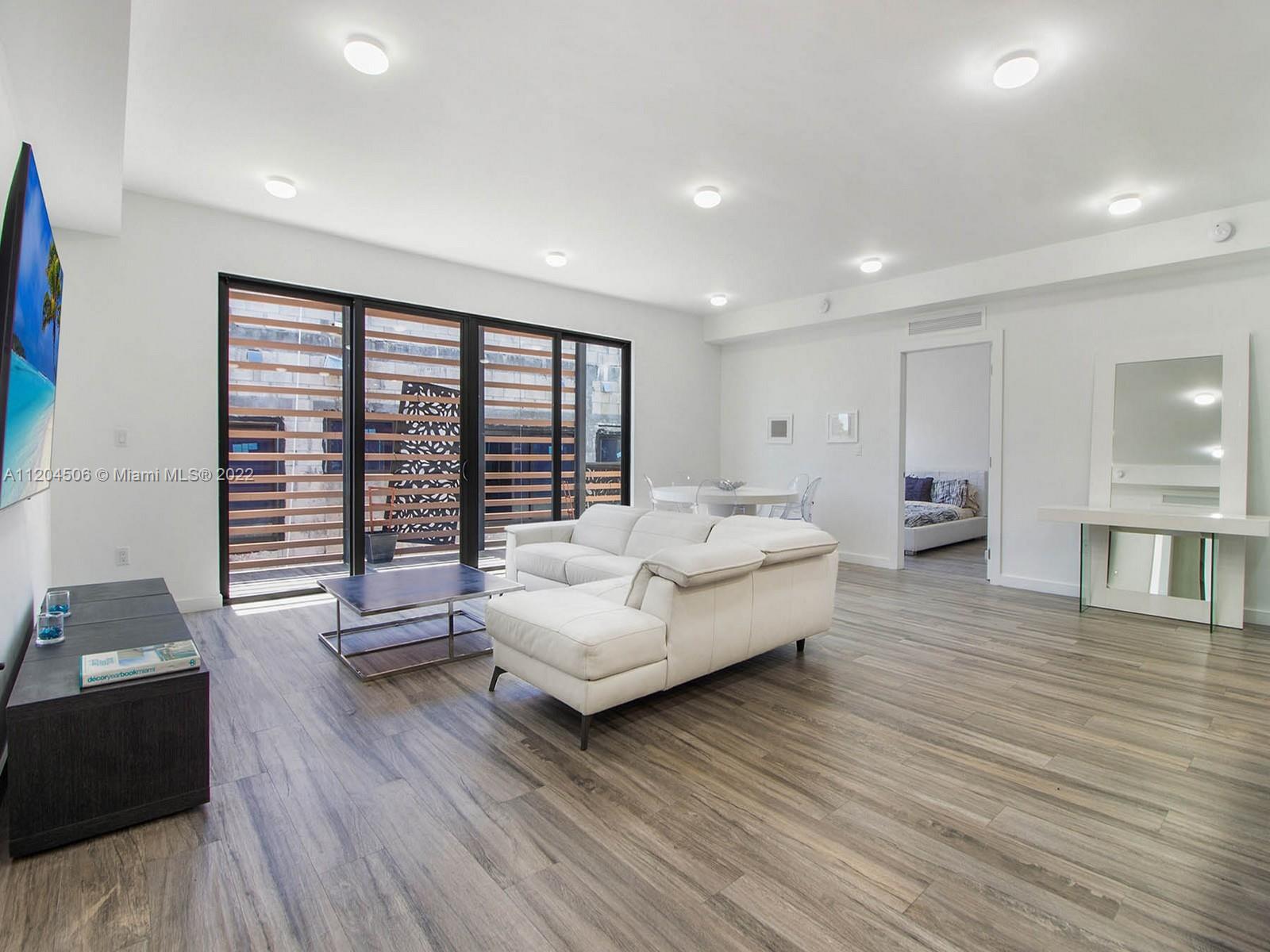 2955 Bird Avenue, Unit PHA Miami, FL 33133 - Photo 9 of 33 a living room with furniture and a large window