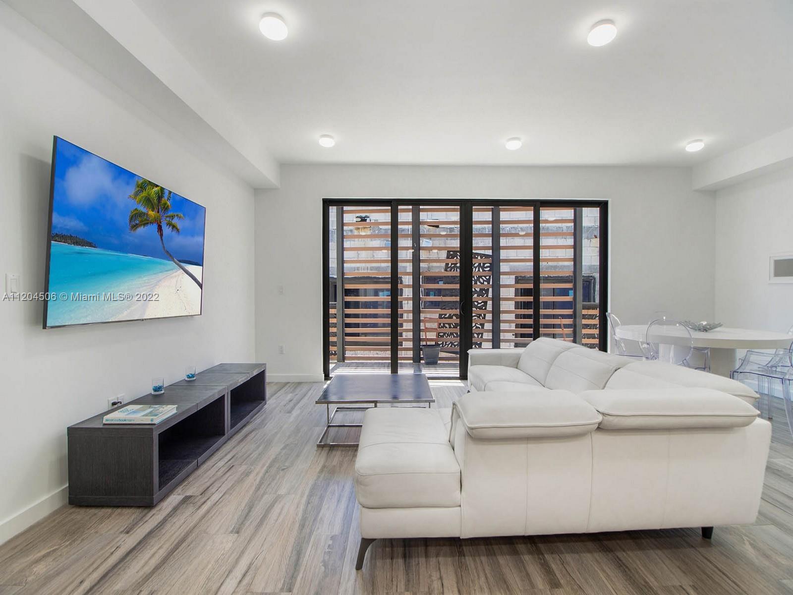 2955 Bird Avenue, Unit PHA Miami, FL 33133 - Photo 10 of 33 a living room with furniture and a large window