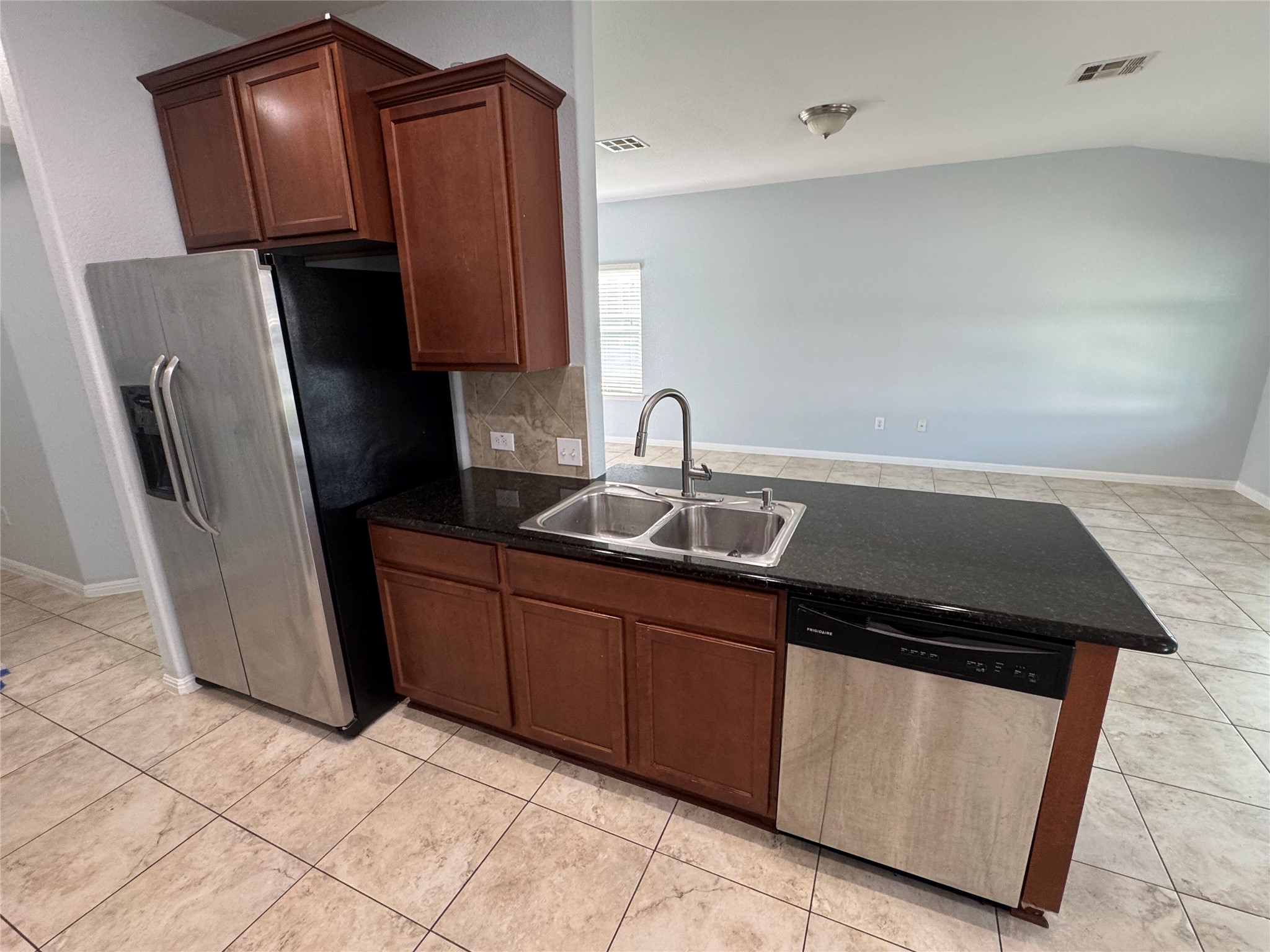 1520 Portchester Castle Path Pflugerville, TX 78660 - Photo 7 of 26 A well-appointed kitchen island offers generous counter space and seamless integration into the living area.