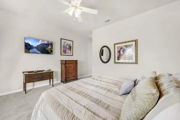a bedroom with a bed and a desk