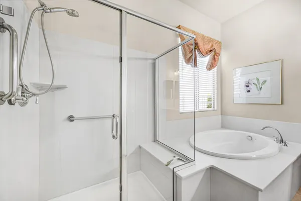 a bathroom with a sink a mirror and a shower