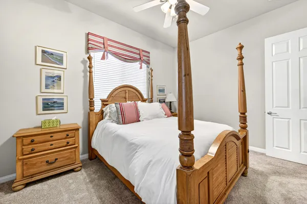 a bedroom with bed and a chandelier
