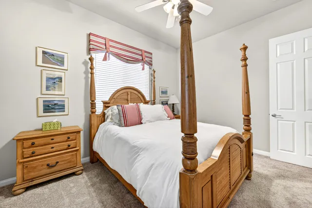 a bedroom with bed and a chandelier