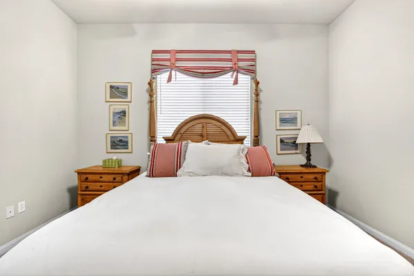 a bedroom with a bed and a night stand