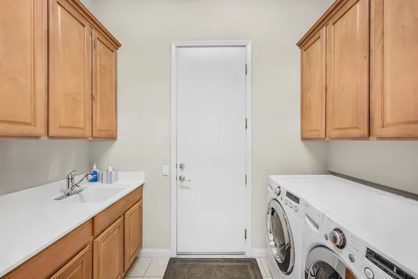 a utility room with a sink washer and dryer