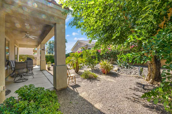 a view of a chair and table in the garden