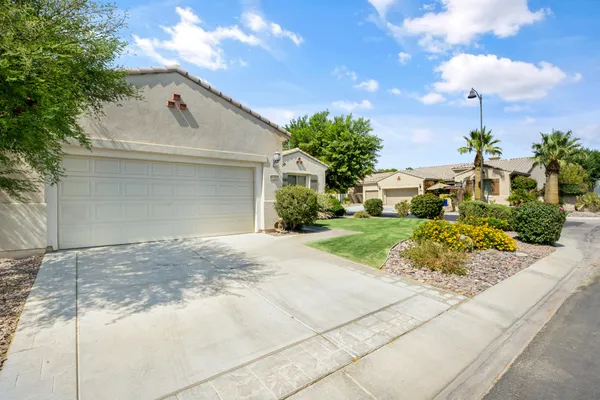 a view of a house with a yard and garage