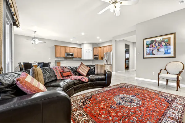 a living room with furniture and a chandelier