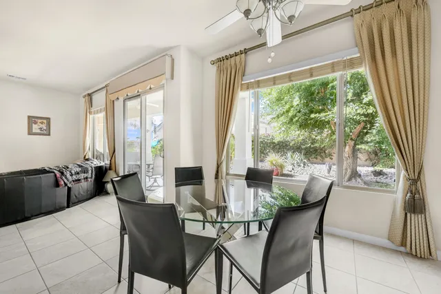 a view of a dining room with furniture window and outside view