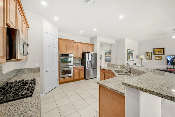 a kitchen with stainless steel appliances granite countertop a sink and cabinets