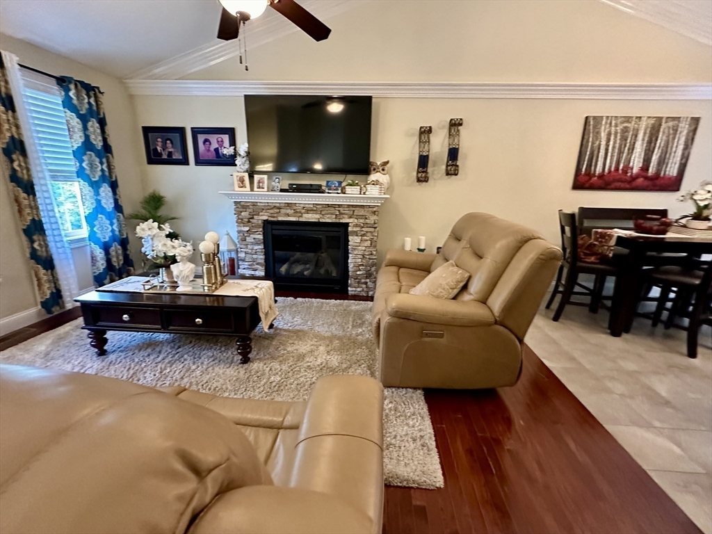 115 Bronson Fall River Fall River, MA 02724 - Photo 11 of 37 a living room with furniture a flat screen tv and a fireplace