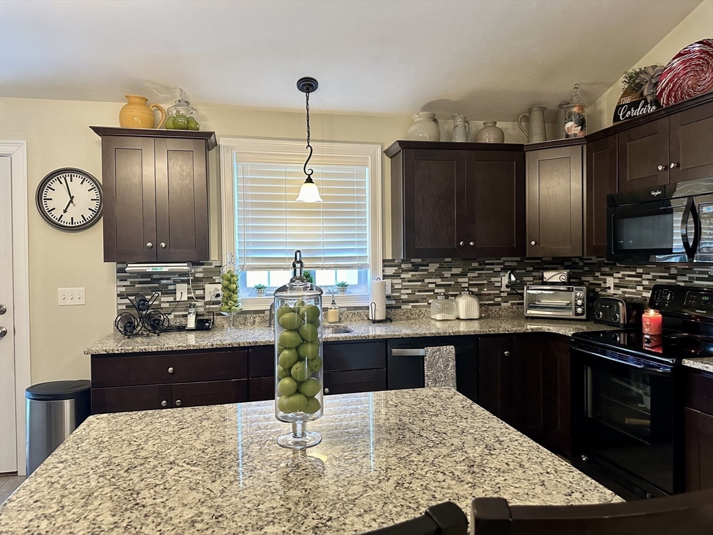 115 Bronson Fall River Fall River, MA 02724 - Photo 17 of 37 a kitchen with kitchen island granite countertop a sink and stove
