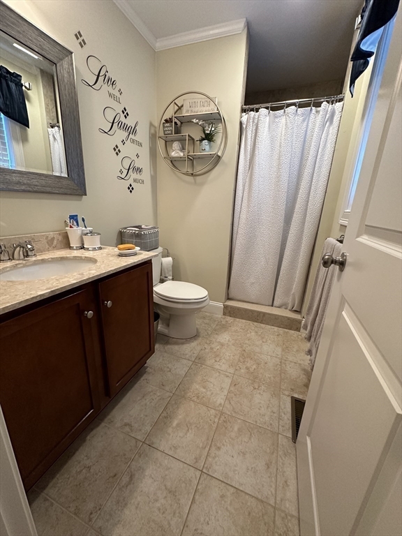 115 Bronson Fall River Fall River, MA 02724 - Photo 21 of 37 a bathroom with a toilet sink vanity and mirror