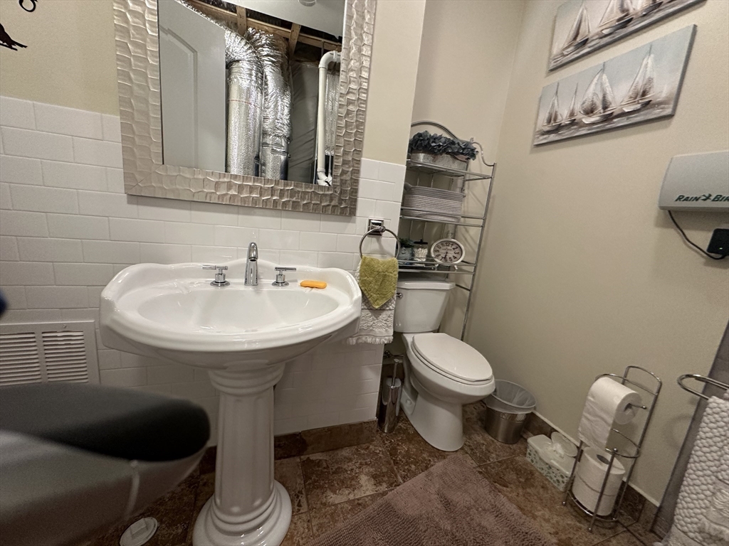 115 Bronson Fall River Fall River, MA 02724 - Photo 33 of 37 a bathroom with a sink toilet and a mirror