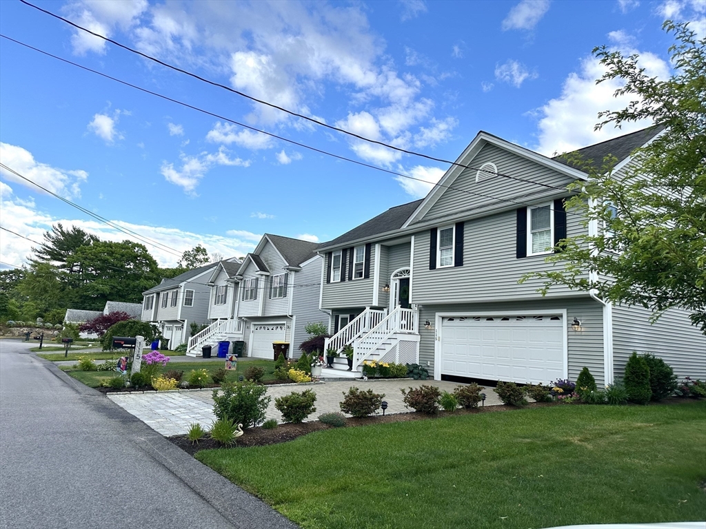 115 Bronson Fall River Fall River, MA 02724 - Photo 4 of 37 a front view of a house with a garden and plants