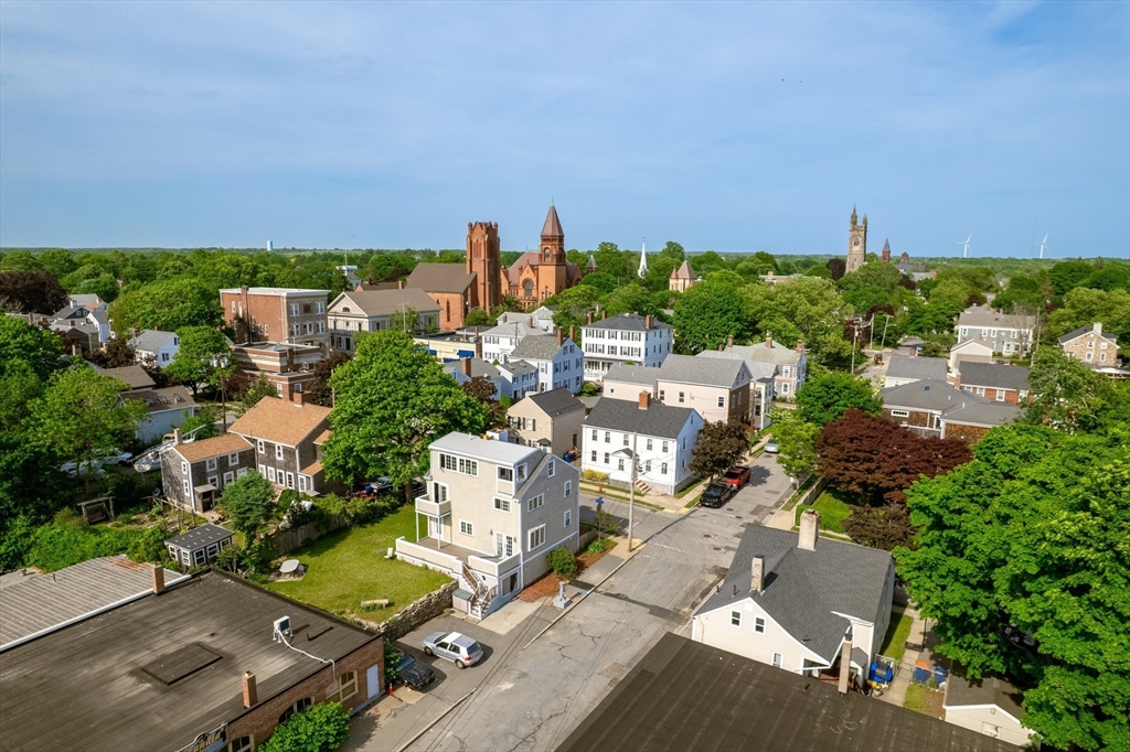 16 Middle Street Fairhaven, MA 02719 - Photo 4 of 34 an aerial view of a city with lots of residential buildings ocean and mountain view in back