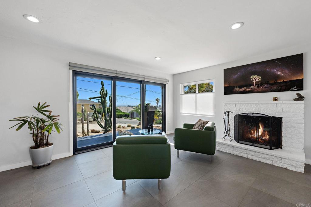 2440 Dunstan Street Oceanside, CA 92054 - Photo 4 of 29 a living room with furniture a flat screen tv and a fireplace