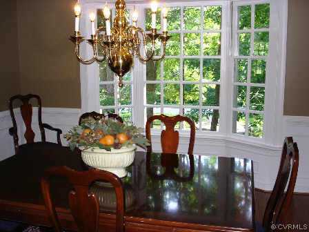 13601 Elmstead Road Midlothian, VA 23113 - Photo 3 of 10 a view of a dining room with furniture a chandelier and wooden floor