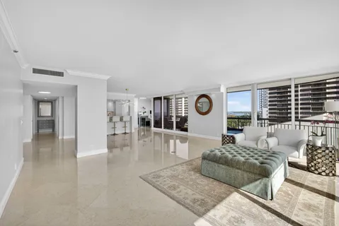 a living room with furniture and a floor to ceiling window