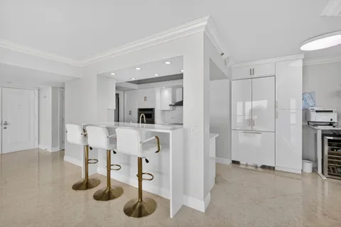a large white kitchen with a large window