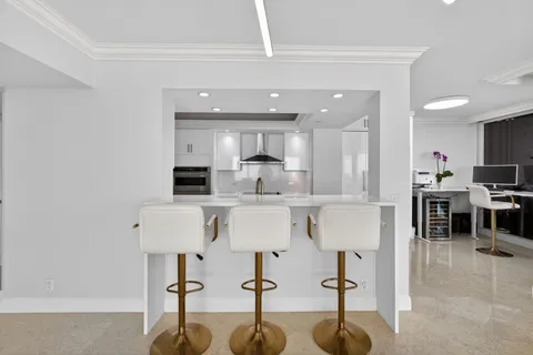 a large kitchen with stainless steel appliances lots of counter space and a sink
