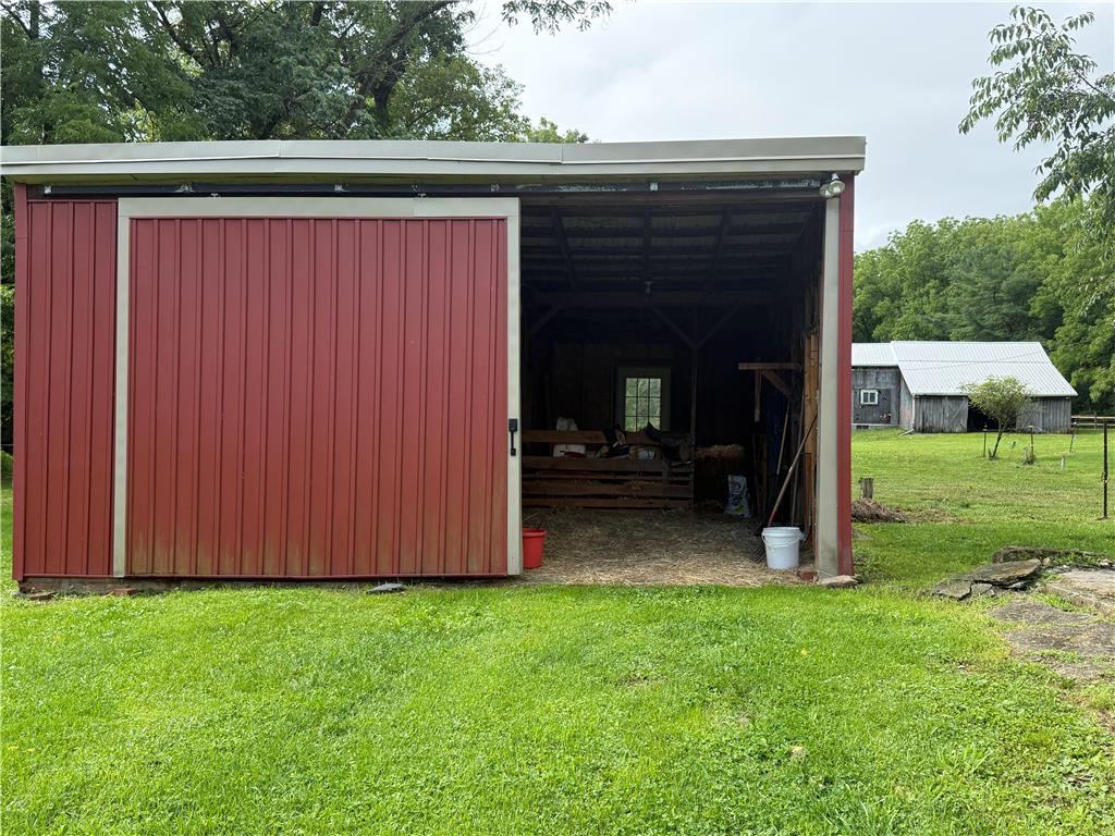 740 Engler Road Nazareth, PA 18064 - Photo 24 of 27 Rustic red barn with sliding door offers ample storage for rural living.