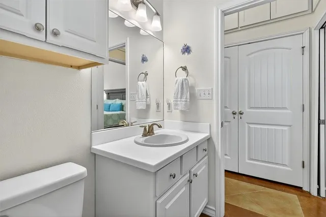 a bedroom with a bed and a potted plant