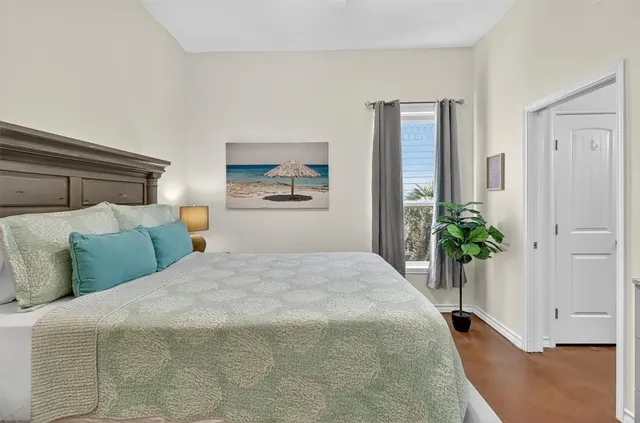 a bedroom with a large bed and a chandelier