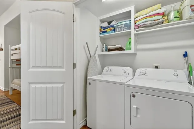 a bedroom with a bed and painting on the wall