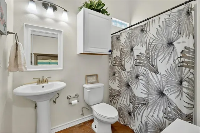 a bedroom with bed and painting on the wall