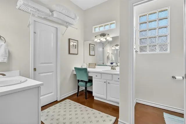 a bathroom with a sink a mirror and a vanity