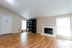 12802 Midway Road, Unit 2003 Dallas, TX 75244 - Photo 13 of 28 an empty room with piano and fireplace