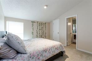 12802 Midway Road, Unit 2003 Dallas, TX 75244 - Photo 19 of 28 a bedroom with a bed and a window