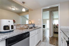 12802 Midway Road, Unit 2003 Dallas, TX 75244 - Photo 2 of 28 a kitchen with granite countertop a sink and cabinets