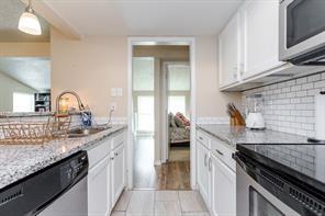 12802 Midway Road, Unit 2003 Dallas, TX 75244 - Photo 3 of 28 a kitchen with granite countertop a sink and stove
