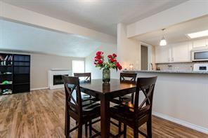 12802 Midway Road, Unit 2003 Dallas, TX 75244 - Photo 8 of 28 a view of a dining room with furniture and wooden floor
