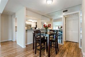 12802 Midway Road, Unit 2003 Dallas, TX 75244 - Photo 10 of 28 a view of a dining room with furniture and wooden floor
