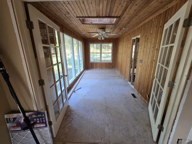 a view of a room with window ceiling fan and windows