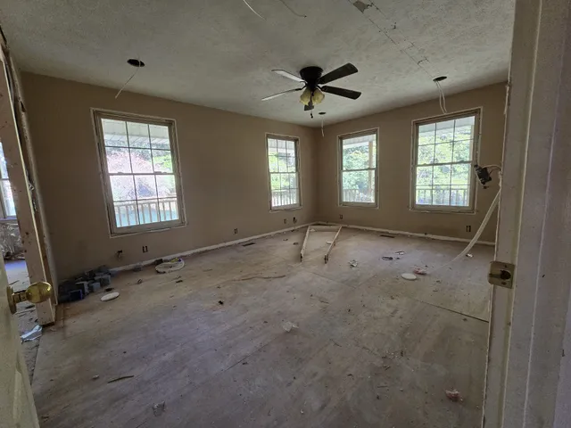 a view of a hallway with wooden walls and windows