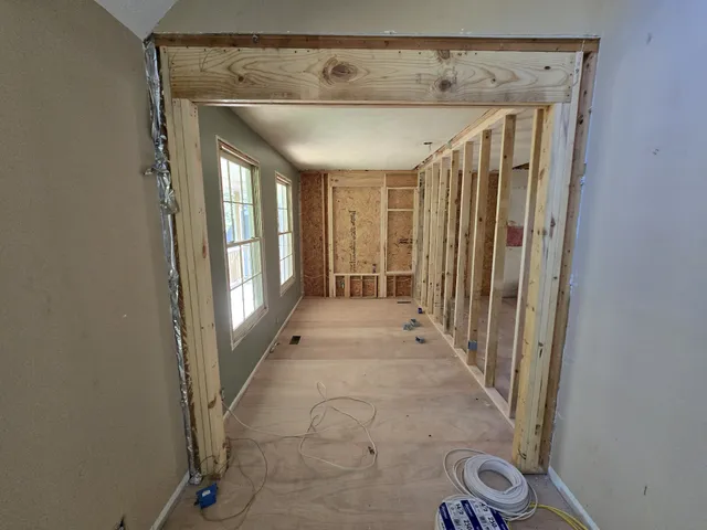 a kitchen with a sink chairs and refrigerator