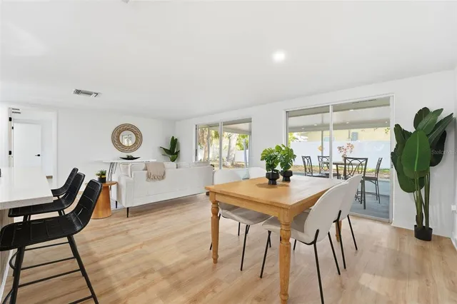 a view of a dining room with furniture and a large window