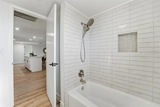 a bathroom with a bathtub and a shower