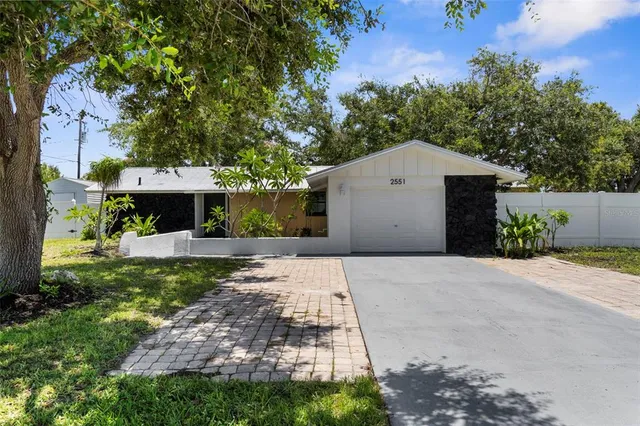 a front view of a house with a yard and a garage
